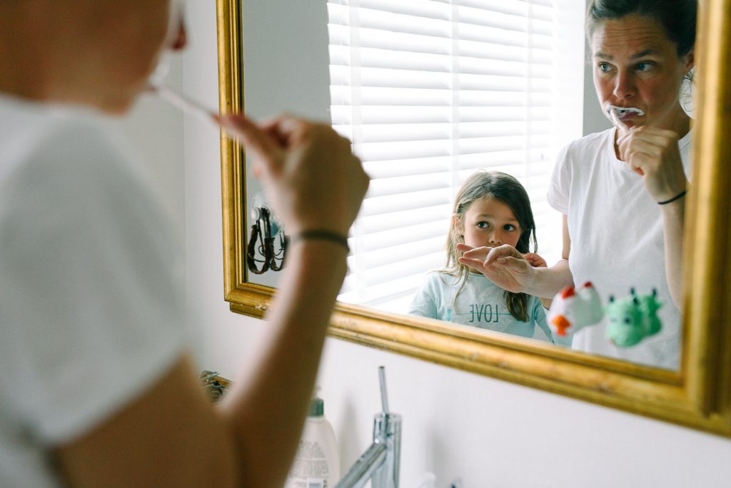 daughter and mum brushing teeth