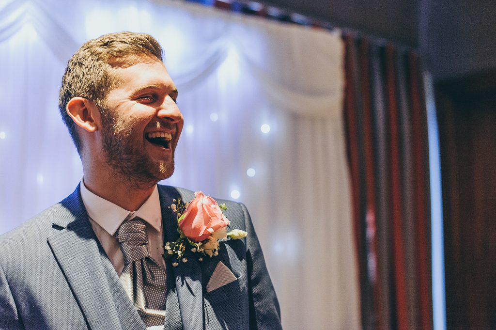 laughing groom