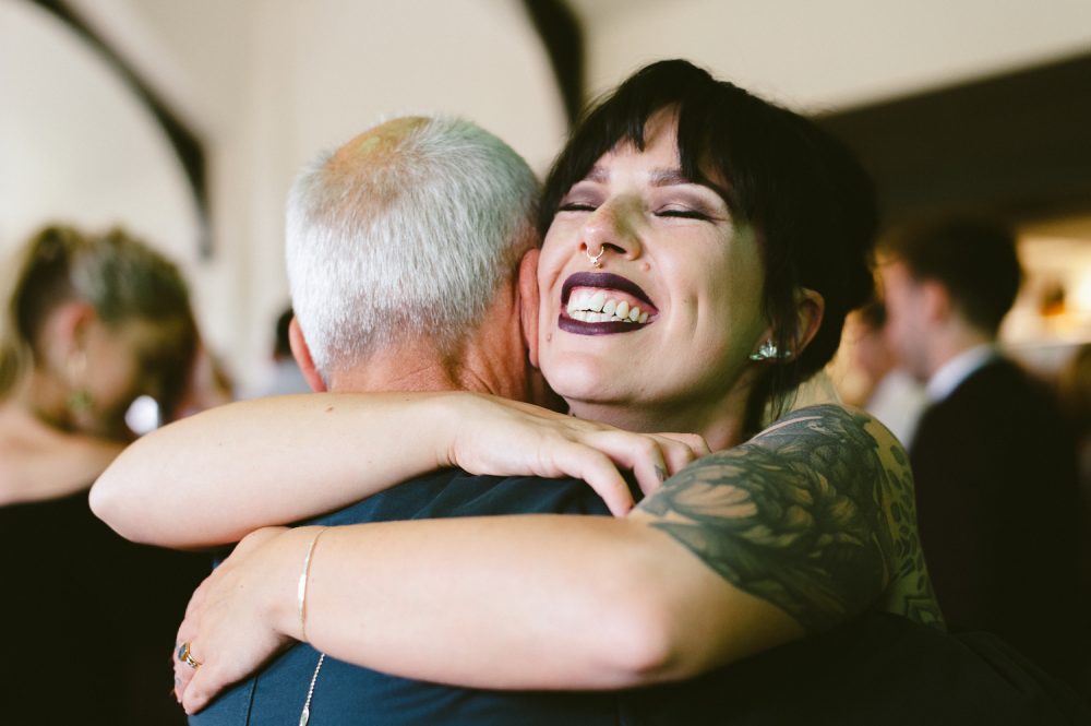 daughter hugging father on wedding day