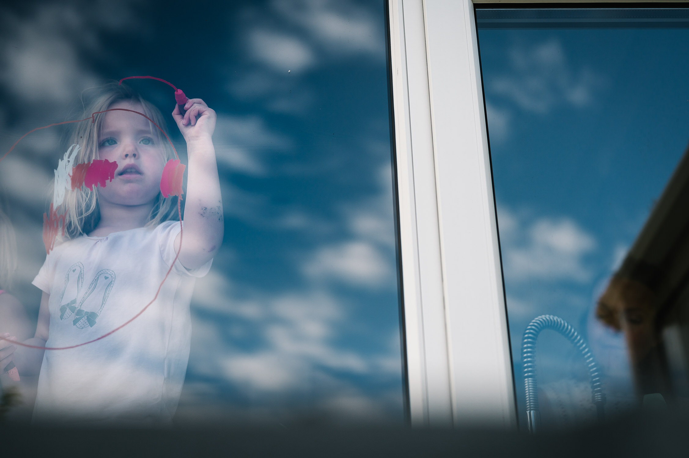 Lockdown Stories child drawing on window during lockdown