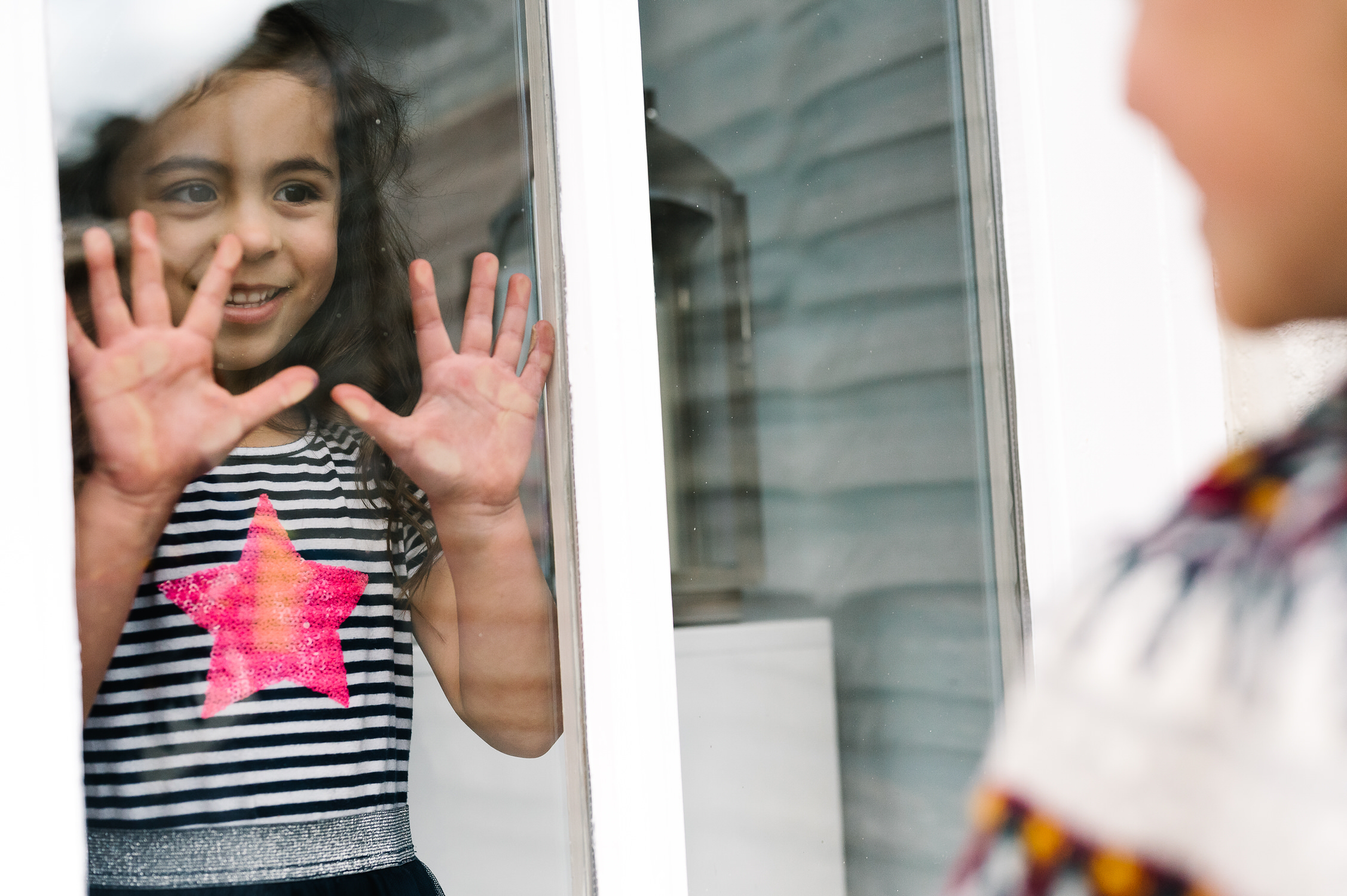 Lockdown Stories little girl behind window corona virus