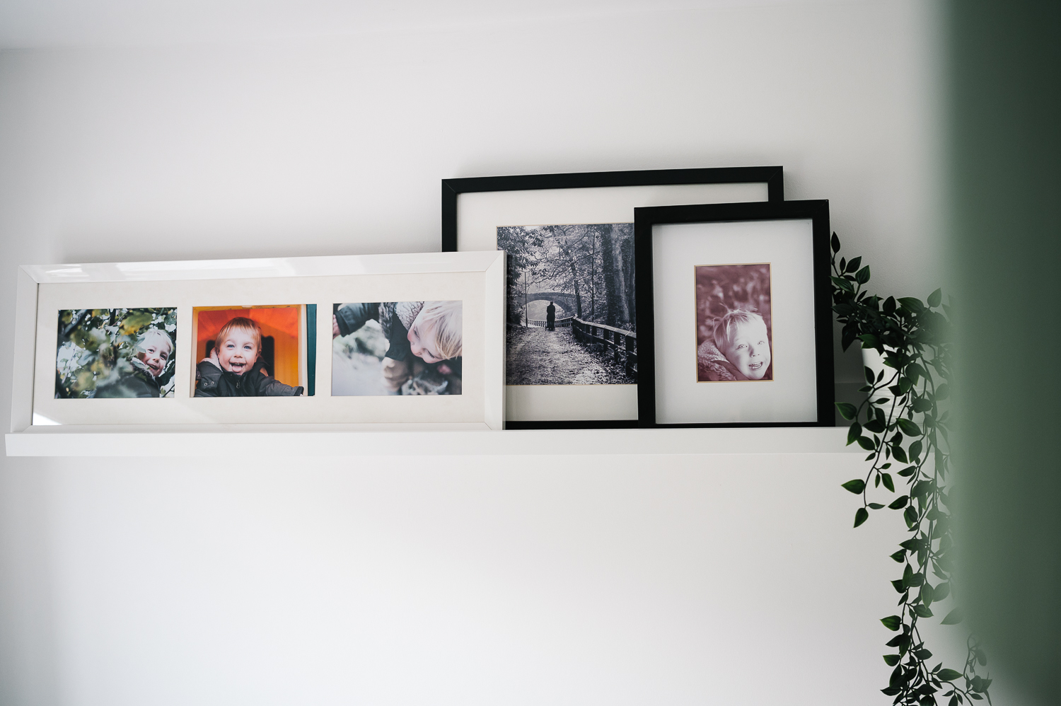 framed boy photos on the wall