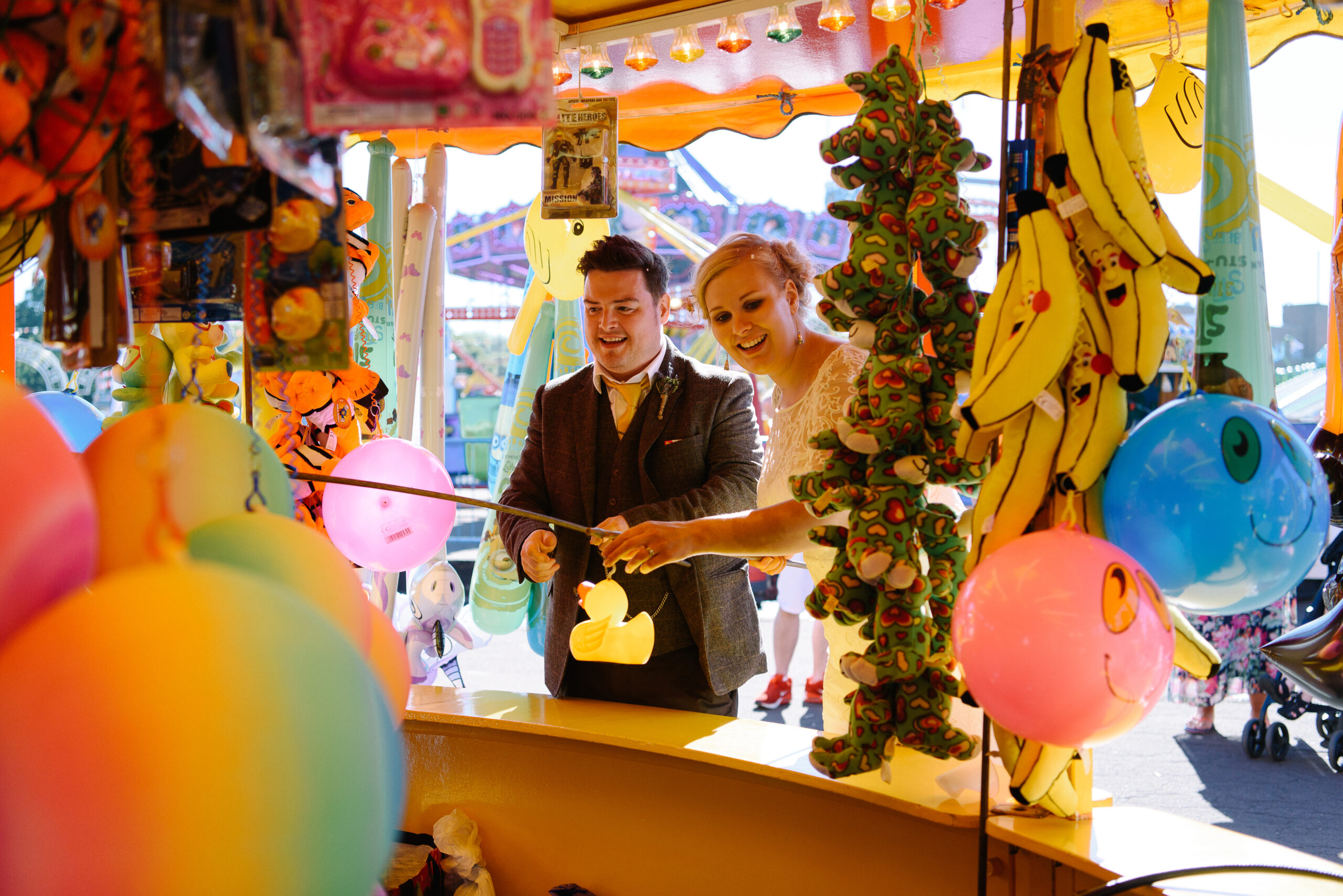 bride and groom playing hook a duck