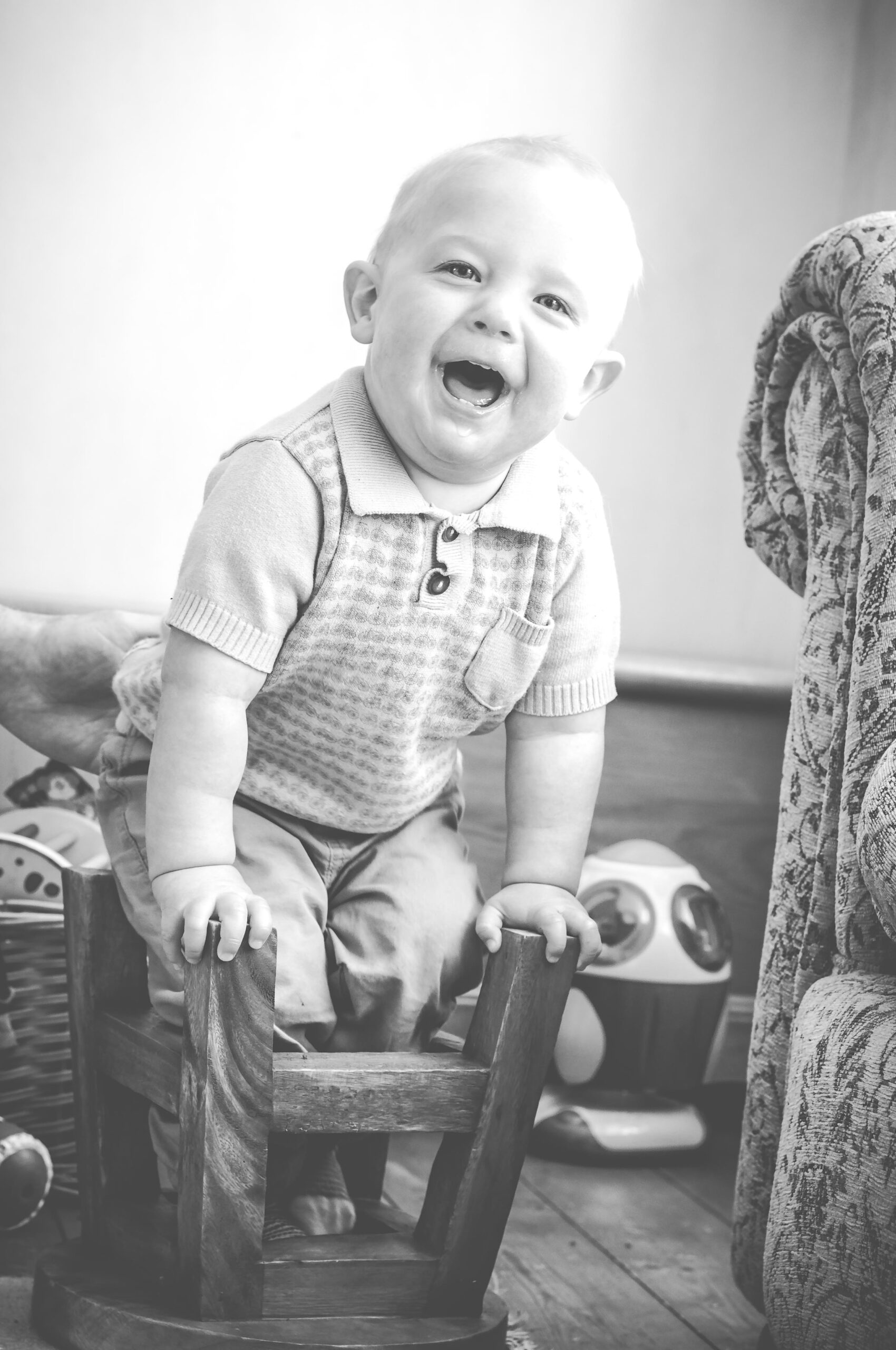 boy sitting in upturned stool