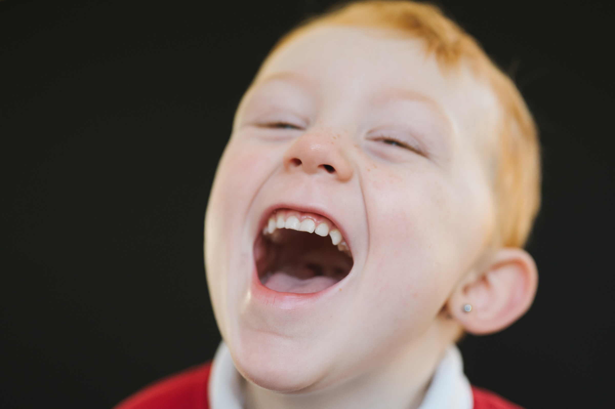 Fine art portrait of boy laughing