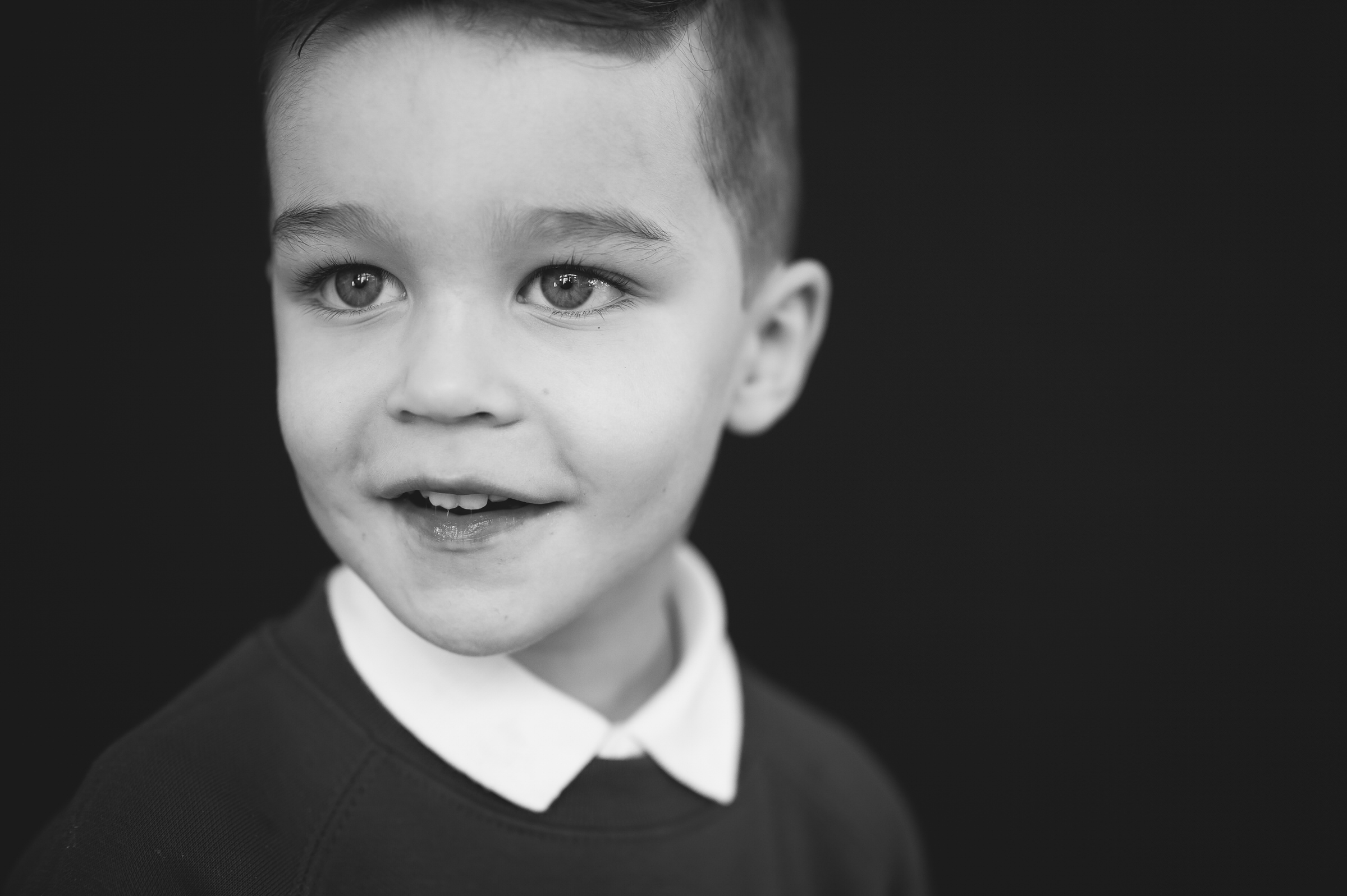 School portrait boy looking towards puppet