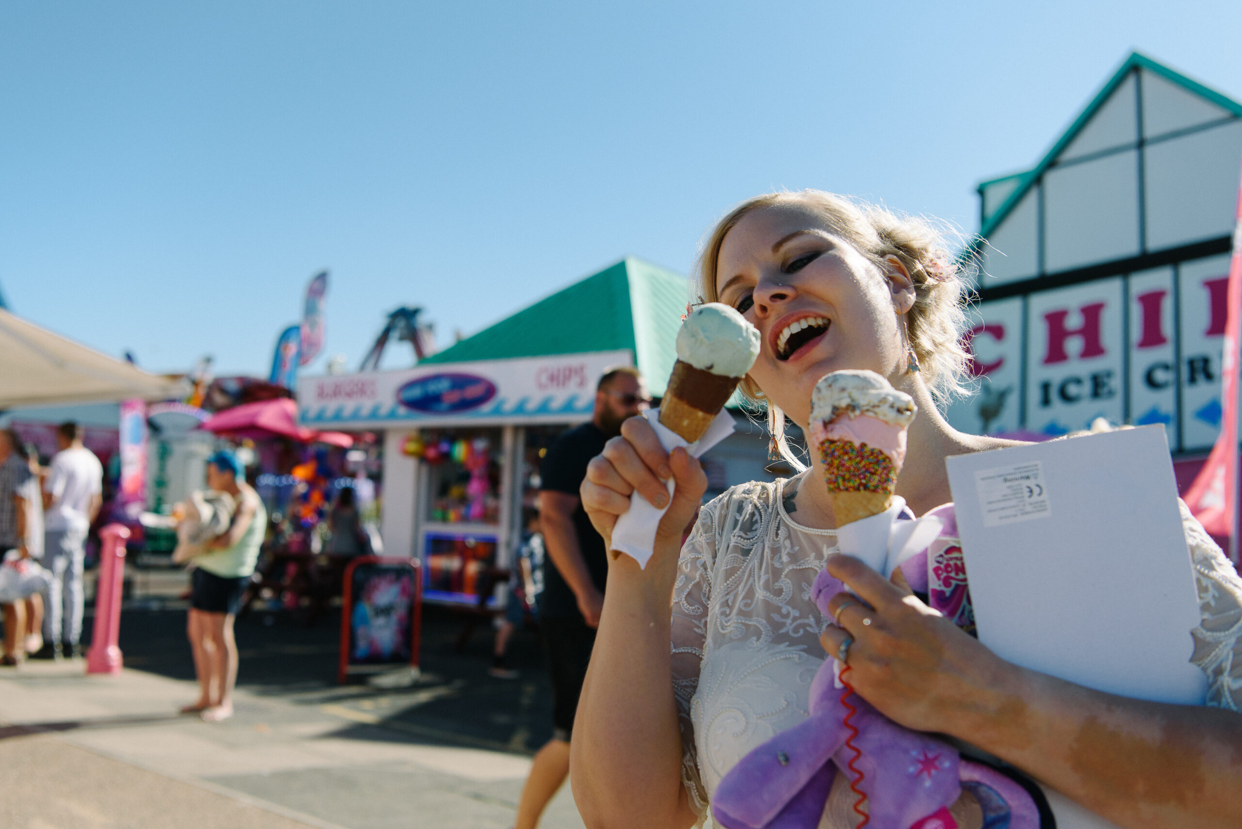 bride eating ice cream at the beach