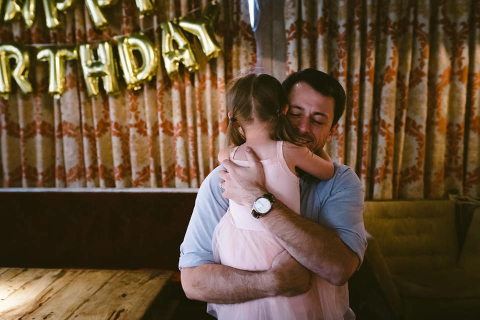 Daddy cuddles little girl
