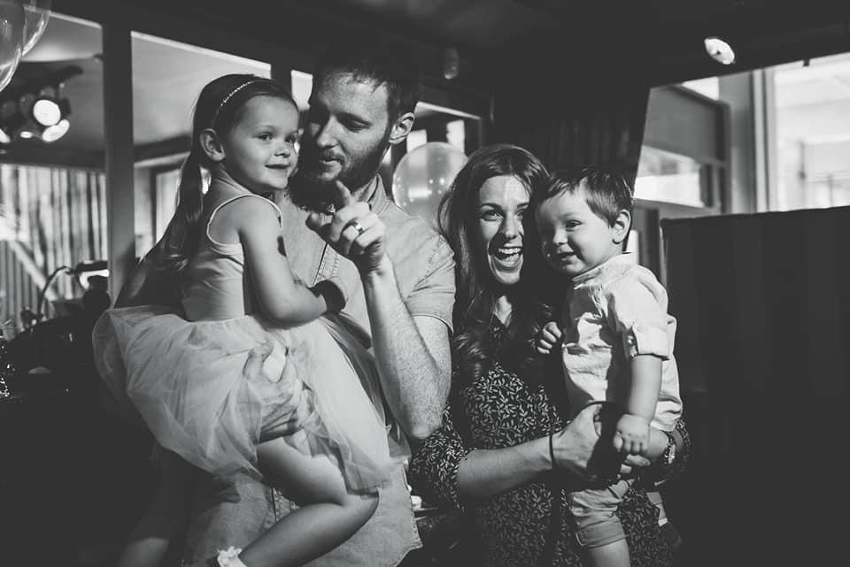 mum and dad cuddle kids