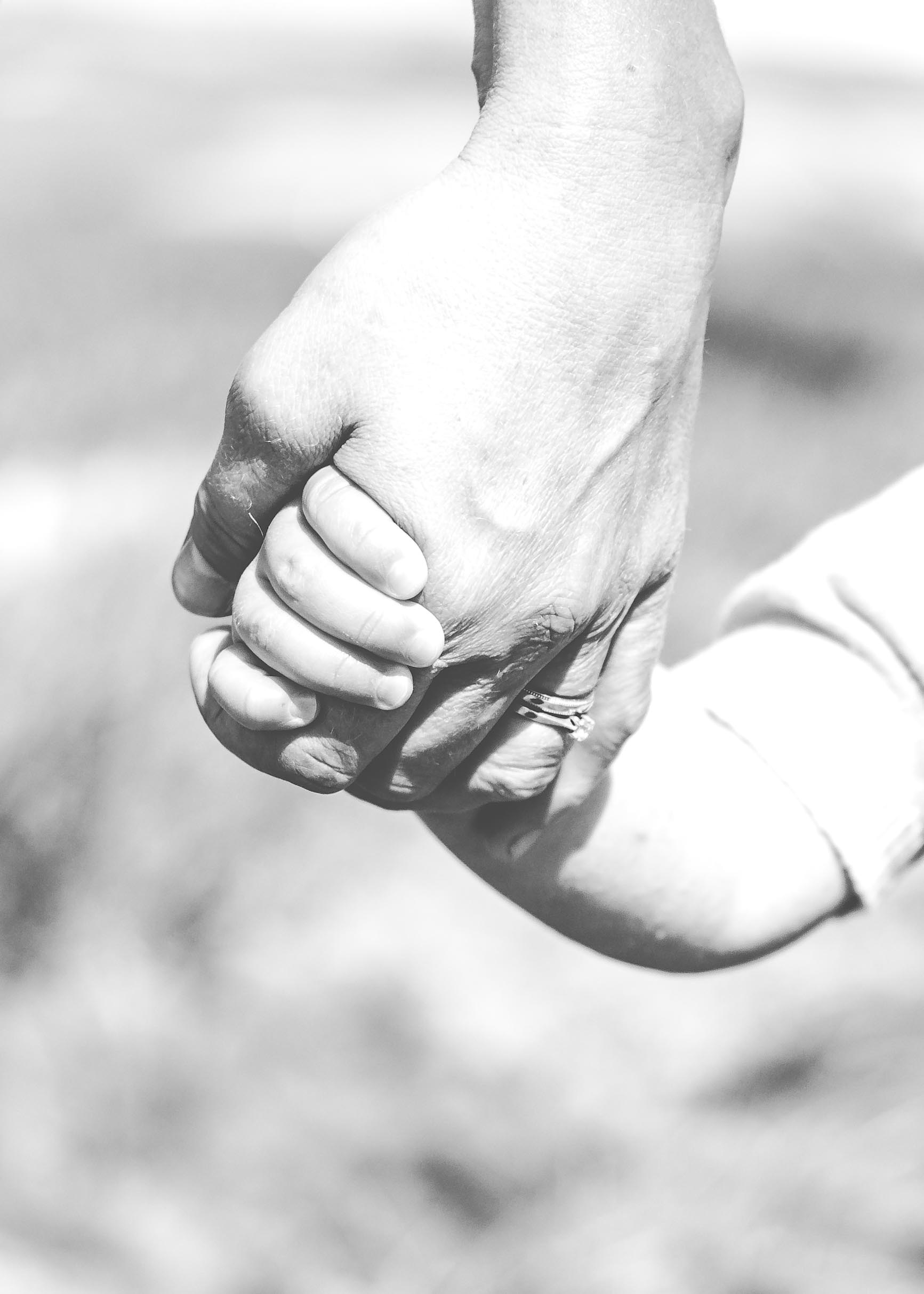 child holding mum's hand