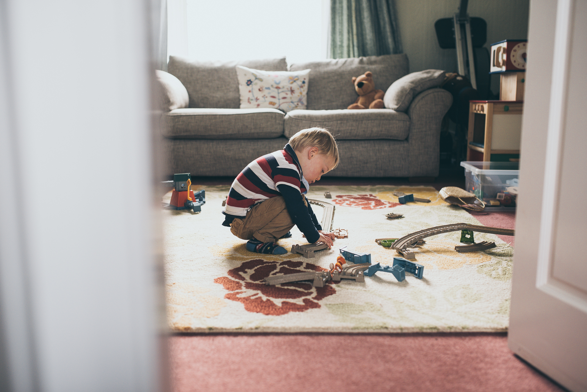 boy playing with train track