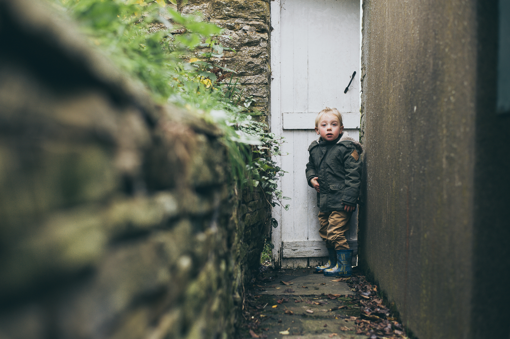 Boy next to white door