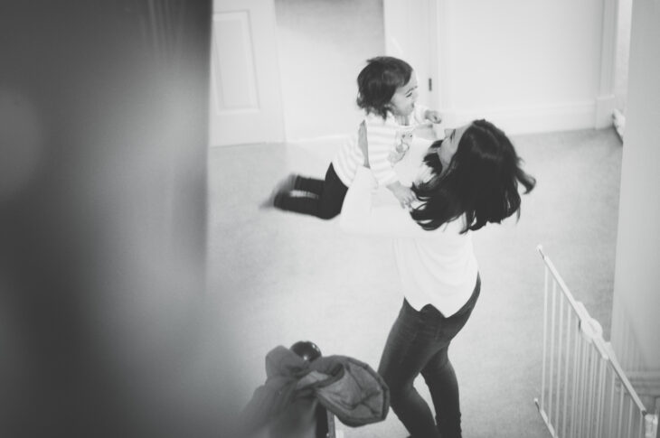 mum twirling daughter on stairs