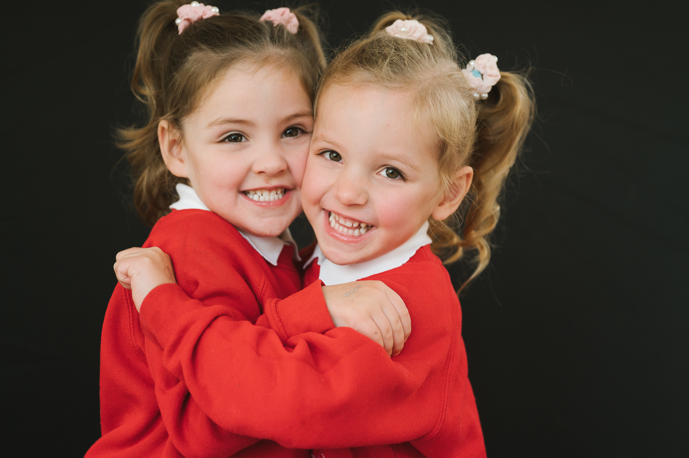 Fine art portrait of twins hugging each other