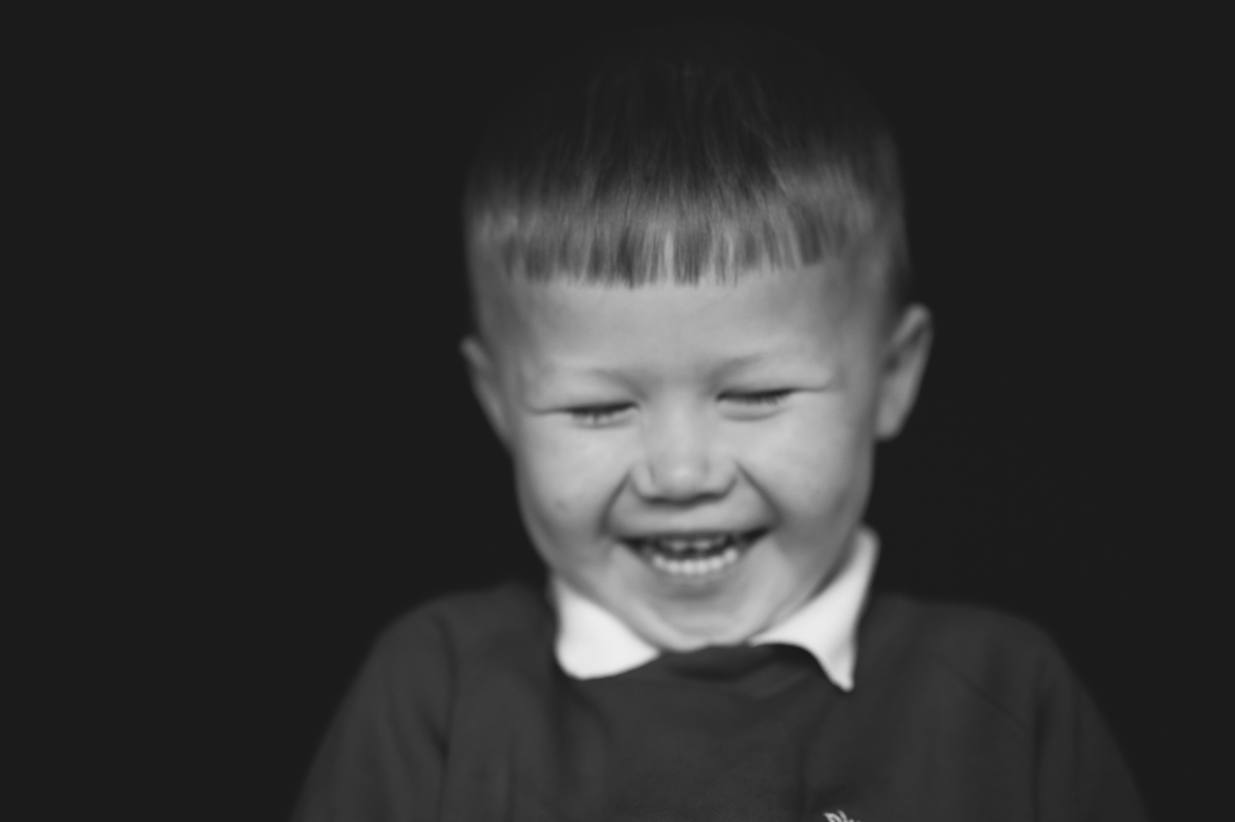 Fine art portrait of boy chuckling to himself
