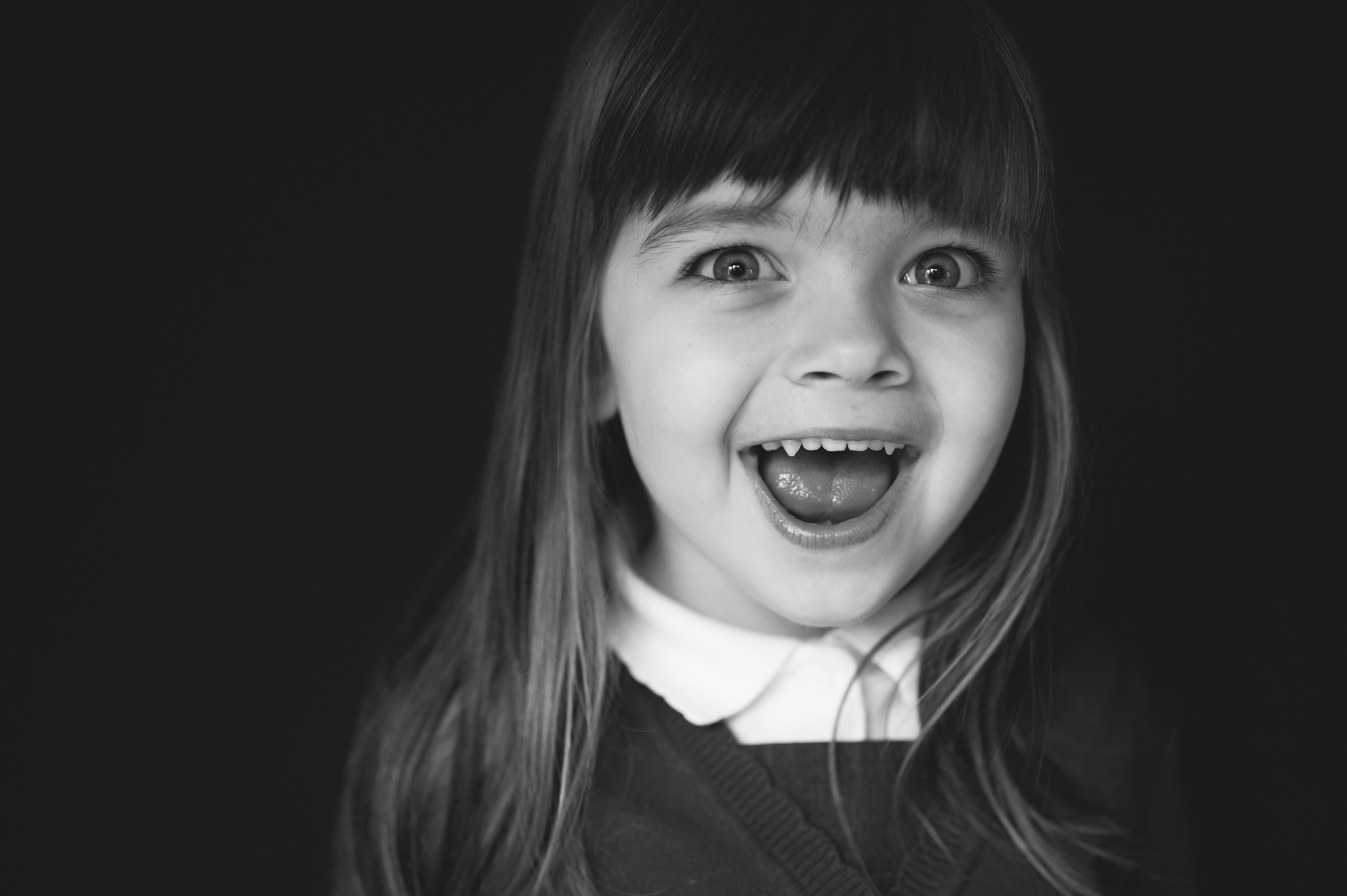 little girl laughing into camera