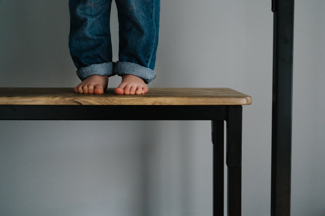 Boy standing on a table