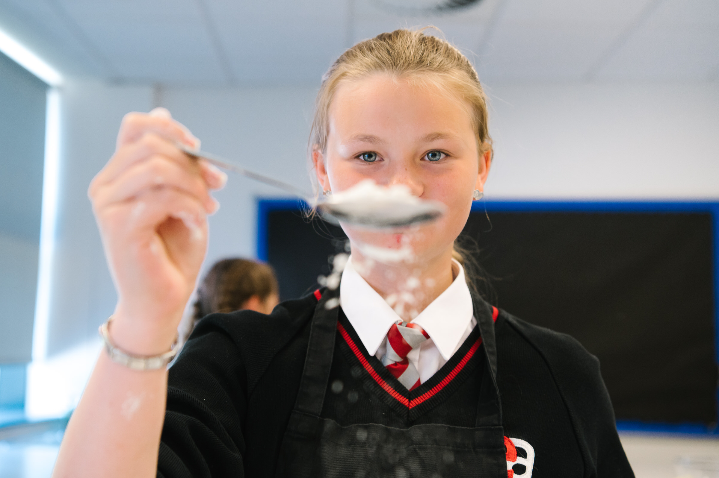 Girl measuring ingredients