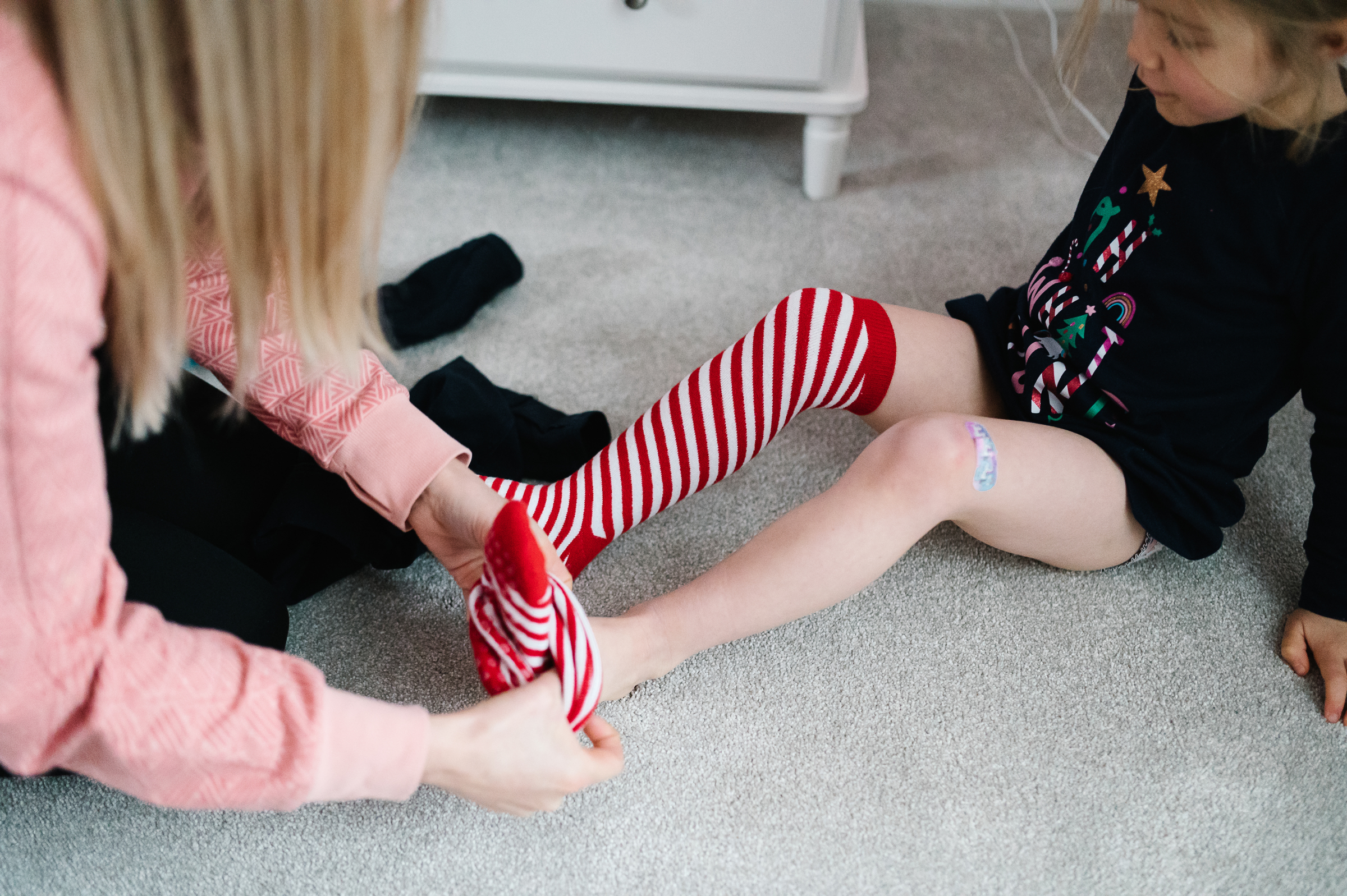 Girl putting on Strippy Socks