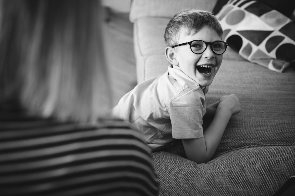 Boy hanging off sofa