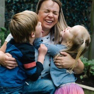 Children giving mum kisses